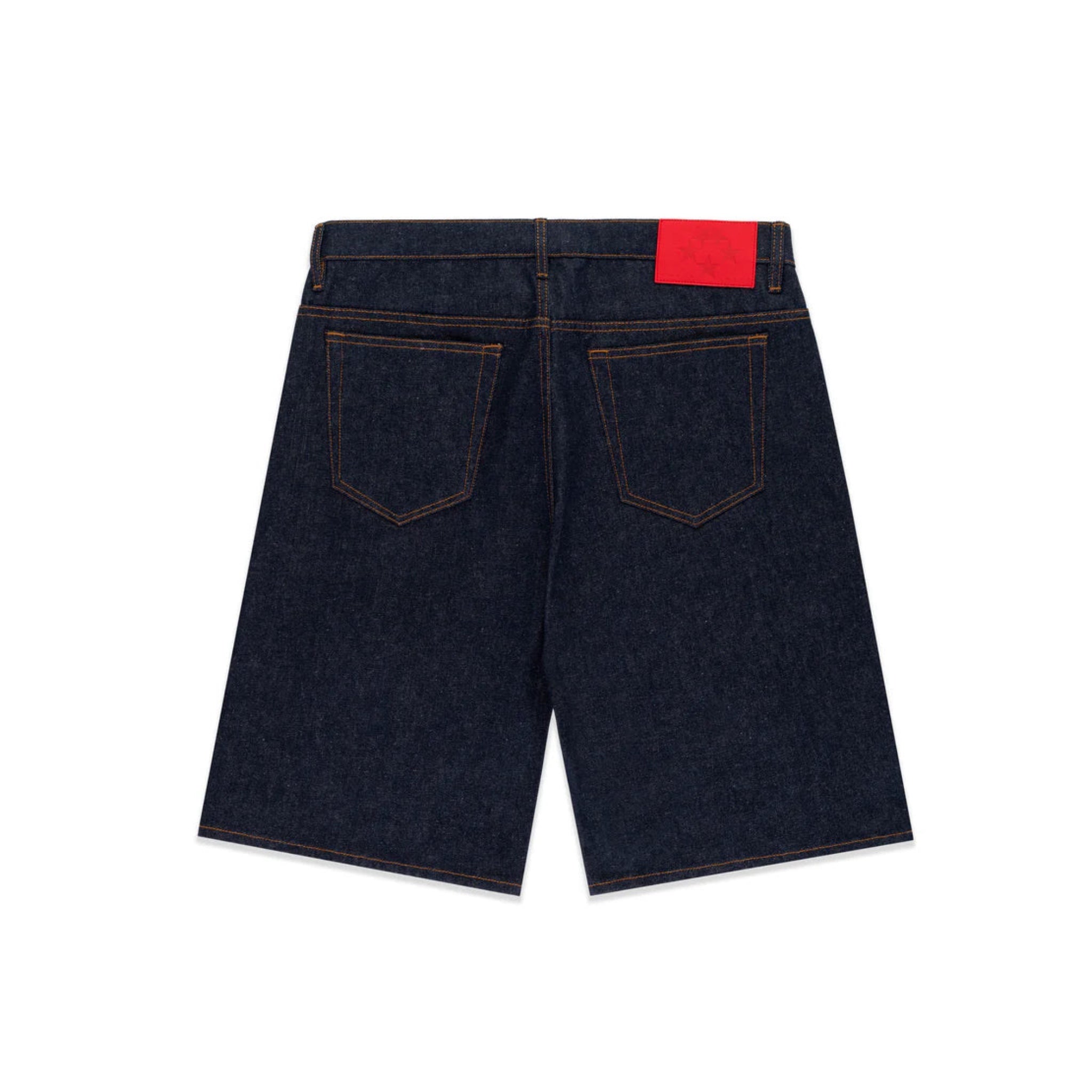Back view of dark blue denim shorts with a red label on a white background