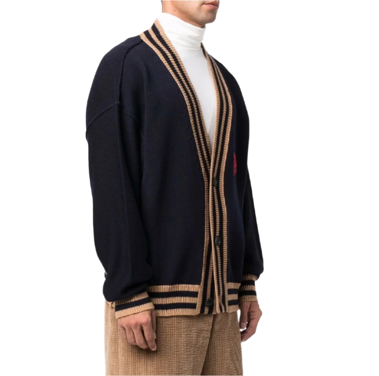 Person wearing a black and beige cardigan on a white background