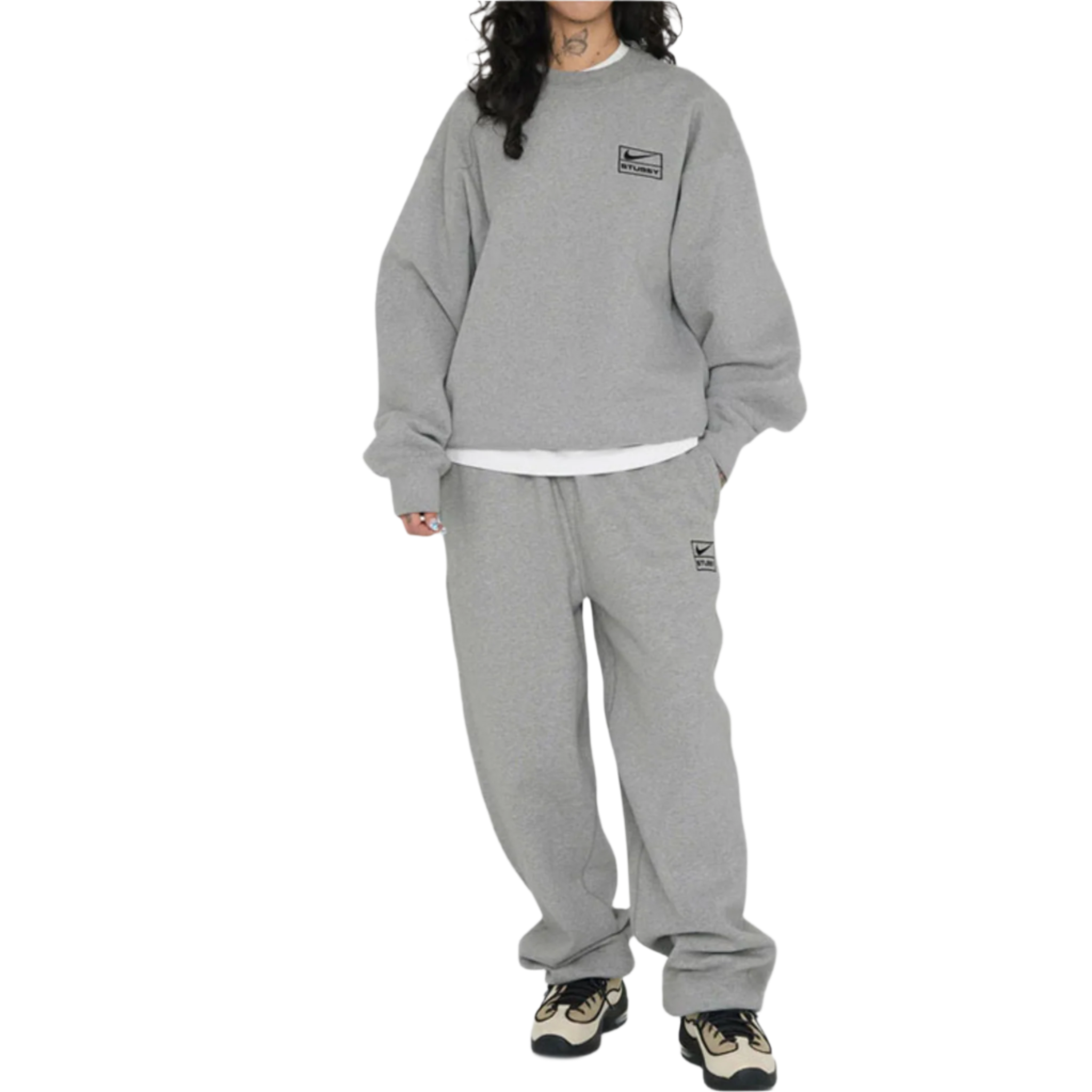 Person wearing a gray sweatshirt and pants set on a white background