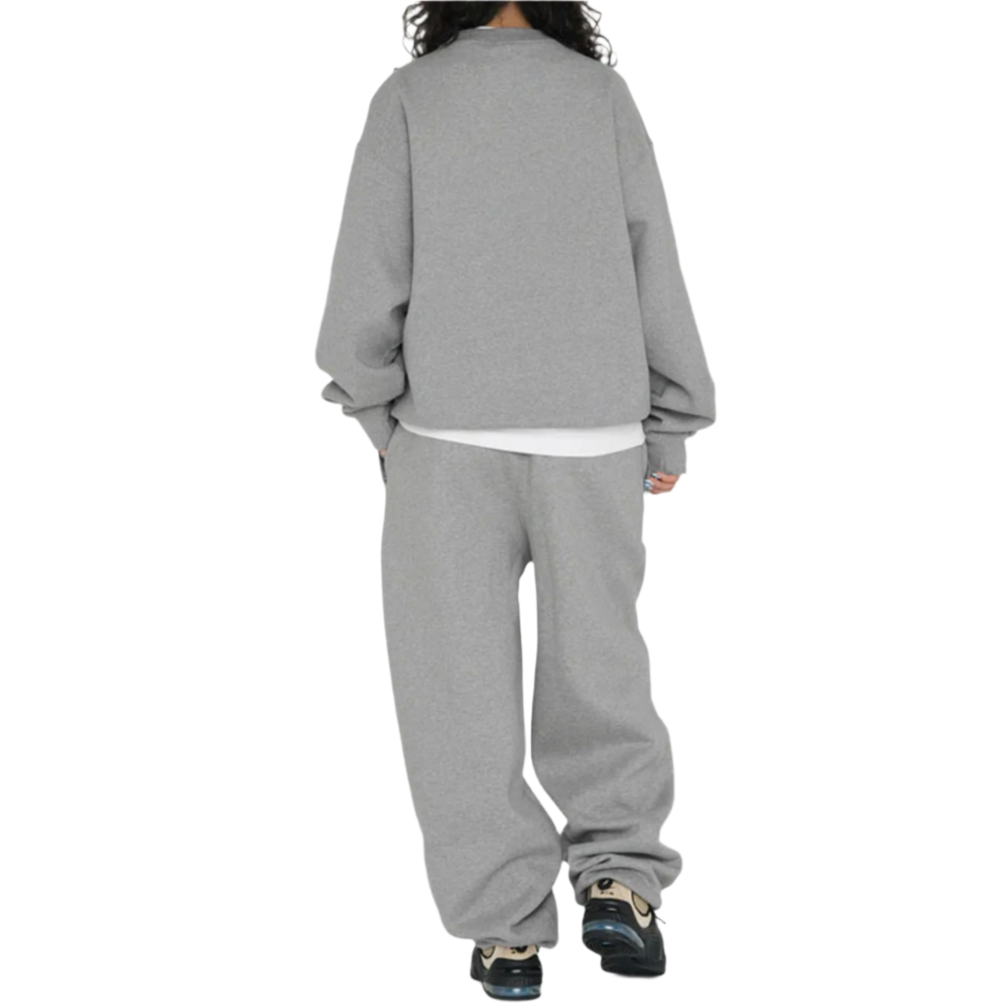 Person wearing a gray sweatshirt and pants set on a white background