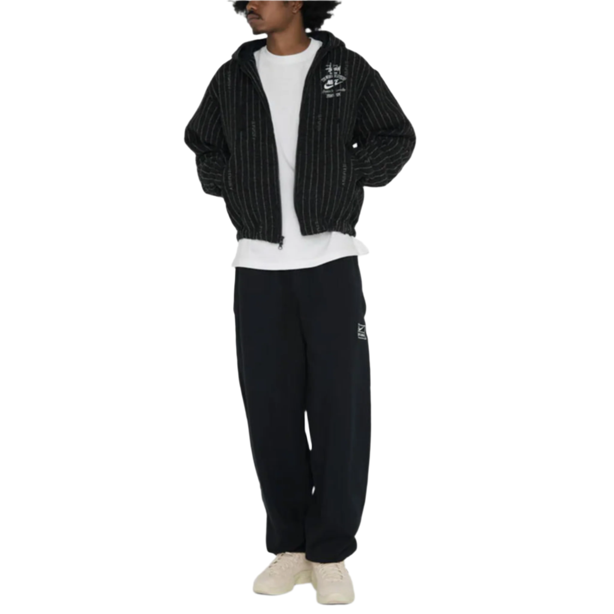 Person wearing a black tracksuit with white text on a white background